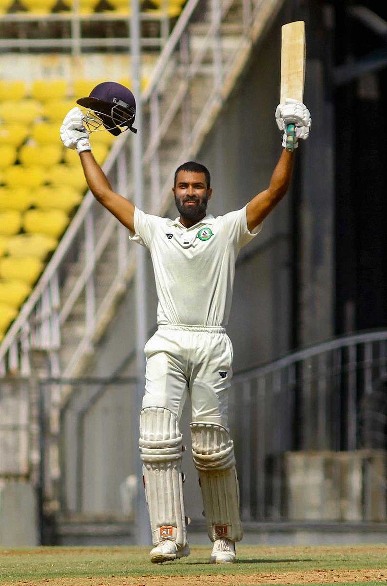 GUTSY: Vidarbha's Akshay Karnewar celebrates after reaching his century against Rest of India in the Irani Cup in Nagpur on Thursday. PTI