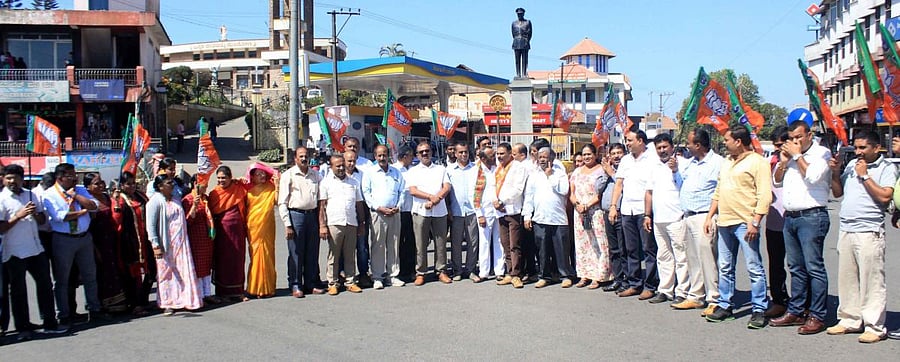 BJP workers protest at General Thimayya Circle in Madikeri on Thursday, opposing the attack on the house of Hassan MLA Preetham Gowda.