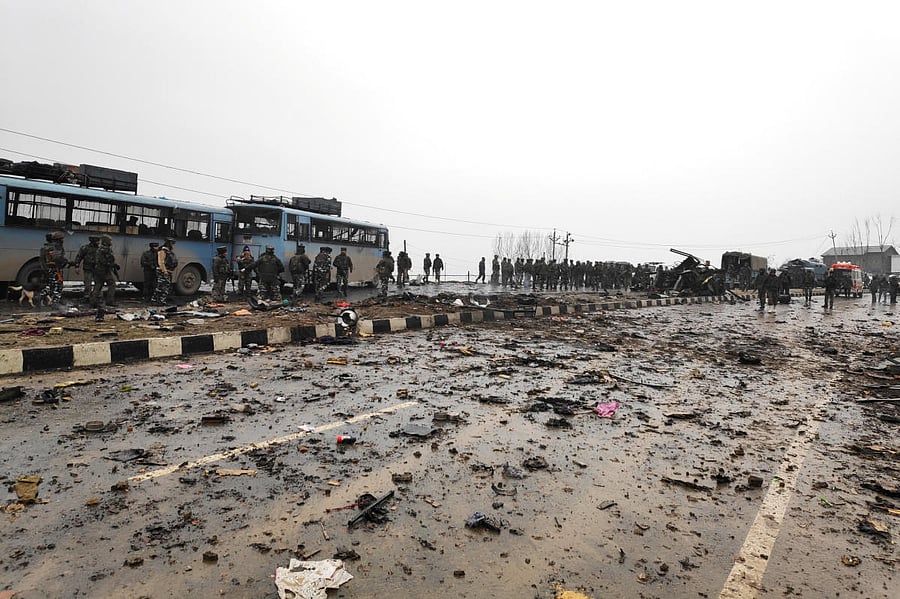 Soldiers examine the debris after an explosion in Lethpora in south Kashmir's Pulwama district. (Reuters Photo)