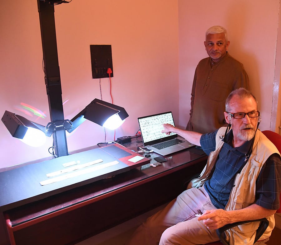 Ken Boydaton from the US explains about restored palm-leaf manuspricts as his collaborator P R Mukund looks on at a lab in Bengaluru. dh photo