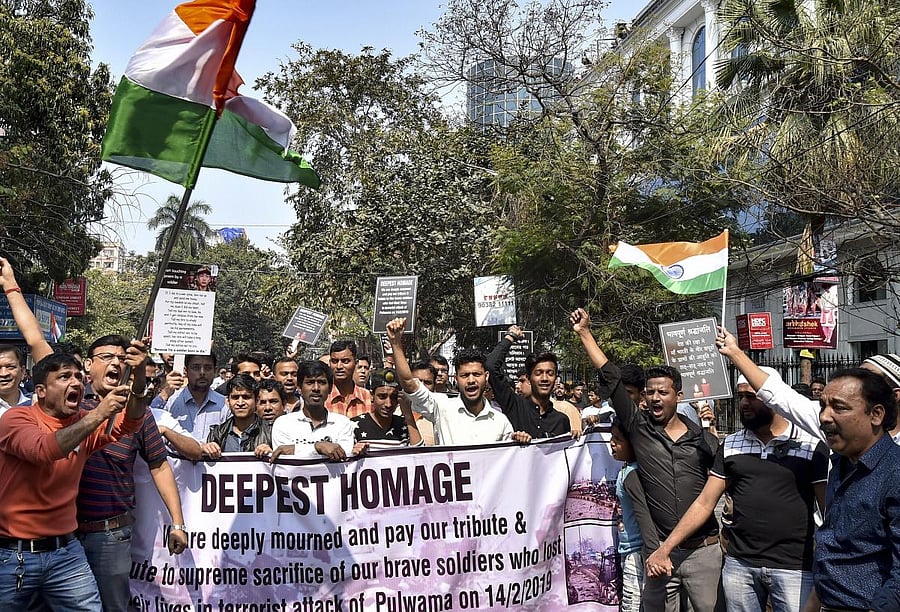 People raise slogans as they hold up Indian tricolour to condemn the Pulwama terror attack, in Kolkata, Sunday, Feb 17, 2019. (PTI Photo)