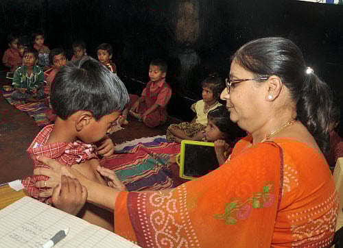 A doctor check-up the medical condition of a school kid. DH photo