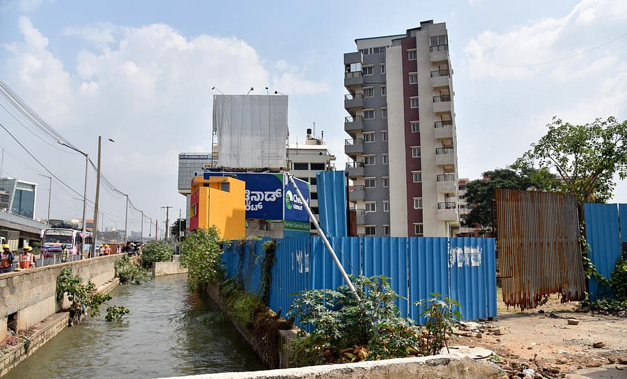 Many allottees say their sites are within touching distance of a stormwater drain (rajakaluve) that criss-crosses the sprawling residential colony, off Magadi Road in southwestern Bengaluru. (DH File Photo. For representation only)
