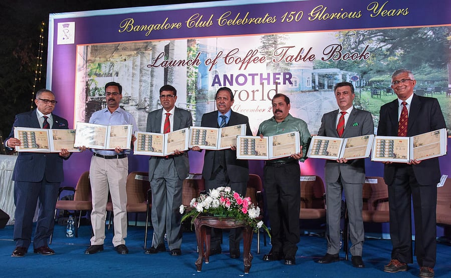 L-R) Harish J Padmanabha, member, General Committee, Bangalore Club; Col Arvind Varma, Postmaster General, Bengaluru; R Ramakrishnan, president, Bangalore Club; former Lokayukta Justice (retd) N Santosh Hegde, Air Marshal AKS Bhadauria, Air Officer Commanding-in-Chief, Training Command of the Indian Air Force; Varun Gurjer, vice president, and Girish Punja, former president, release a coffee-table book to mark the club’s 150th year on Saturday. DH photo