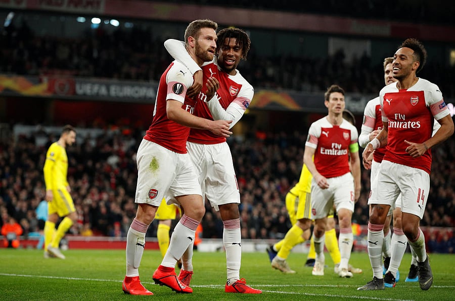 THUMPING HEADER: Arsenal's Shkodran Mustafi (left) celebrates with team-mates after scoring his side's second goal against BATE Borisov. Reuters