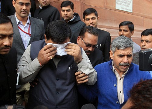 An MP affected by pepper gas sprayed by suspended Congress MP L Rajagopal during presentation of Telangana Bill in the Lok Sabha, coming out of Parliament House in New Delhi on Thursday. PTI Photo by Kamal Singh