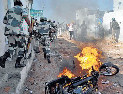 A motorcycle set on fire by a mob burns during clashes between two communities on the outskirts of Hyderabad on Wednesday. Reuters photo