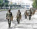 Securitymen patrol the hi-tech city area during the bundh called by the Joint Action Committee for separate Telangana statehood in Hyderabad on Wednesday. PTI