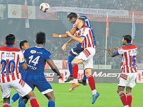valiant effort: Chennaiyin FC's Mailson Alves (airborne right) tries to score of a corner kick during their tie against Atletico de Kolkata at the Salt Lake stadium on Wednesday in Kolkata. Kolkata won 2-1. isl media