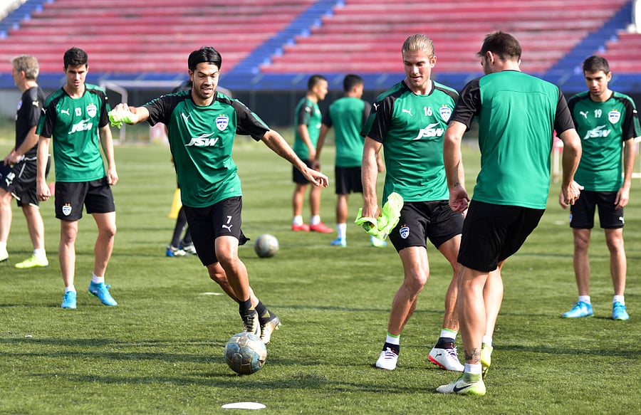 Bengaluru FC's Miku (left) and Erik Paartalu (centre) during a training session on Saturday. DH Photo/ BH Shivakumar