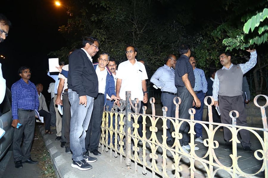 BBMP Commissioner N Manjunath Prasad inspects a footpath on Monday night.