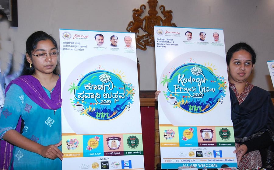 Kodagu Deputy Commissioner P I Sreevidya (right) and Zilla Panchayat CEO Lakshmi Priya release the logo of Kodagu Pravasi Utsav in Madikeri on Tuesday.