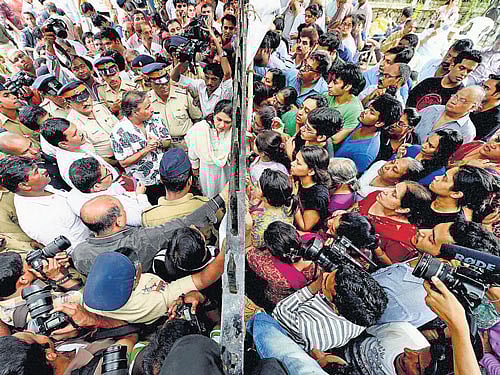 Campa Cola residents block the entrance for the BMC officials who arrived to disconnect the water and electricity supply of the society, in Mumbai on Saturday. PTI photo