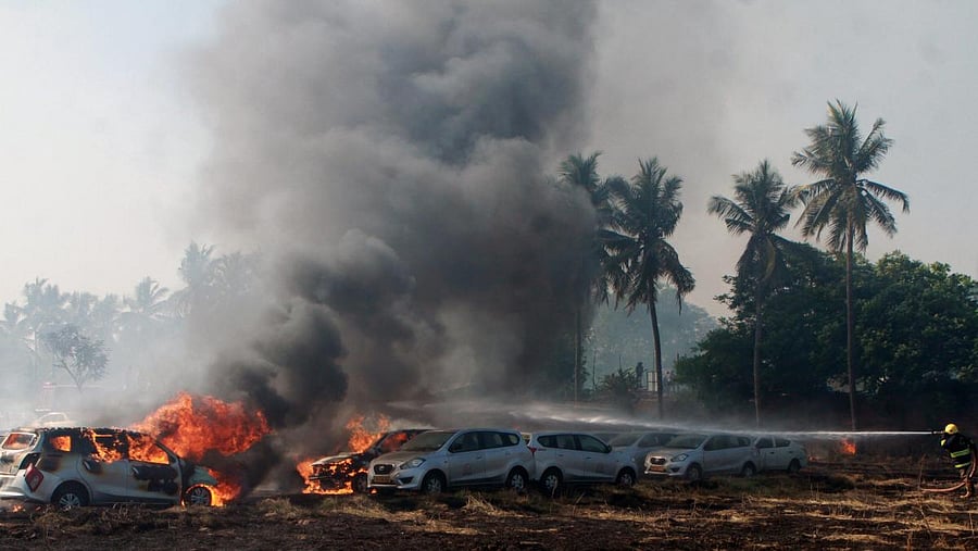 Smoke and flames rising after a major fire broke out in a car parking space opposite to Ramachandra Medical College in Porur, Chennai on Sunday. PTI photo