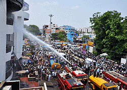 Fire personnel dousing a fire that broke out in a commercial complex in Coimbatore on Thursday. PTI Photo