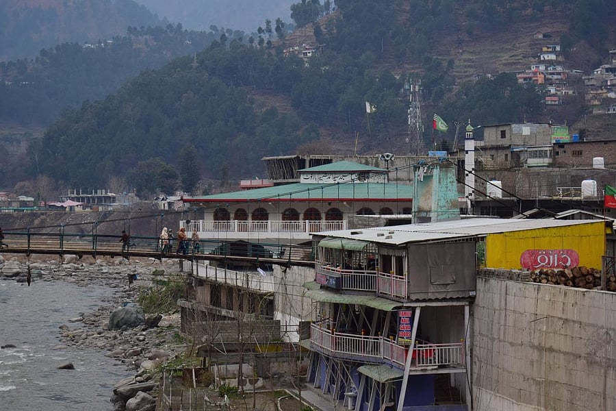 Pakistan villagers cross a bridge in Balakot, Pakistan, Tuesday, Feb. 26, 2019. Maj. Gen Asif Ghafoor, a military spokesman, said the Indian "aircrafts" crossed into the Pakistan-controlled Muzafarabad sector of Kashmir, which is split between the two cou