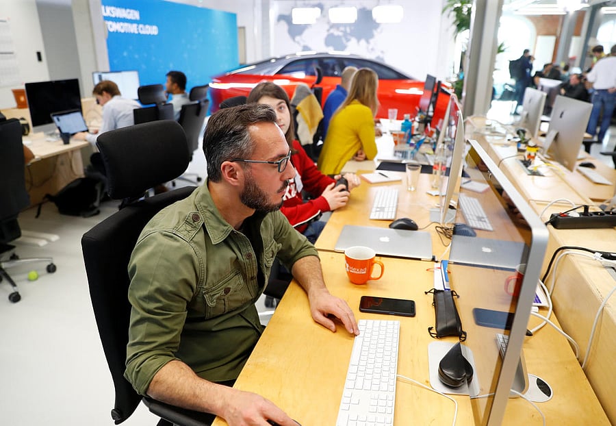 Software developers of the VW digital lab are seen during Microsoft CEO Satya Nadella and Volkswagen CEO Herbert Diess's news conference in Berlin, Germany on February 27, 2019. REUTERS