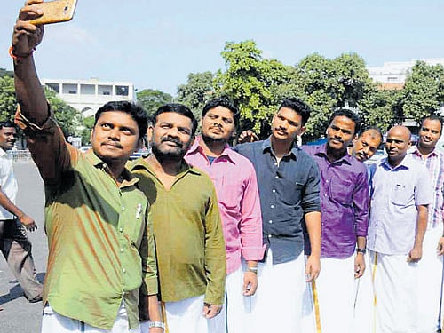 Government employees in Tamil Nadu take a selfie on World Dhoti Day on Wednesday. DH PHOTO