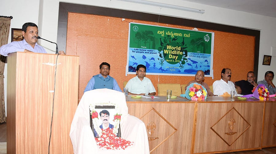 Additional Principal Chief Conservator of Forests B P Ravi speaks during the World Wildlife Day programme at Aranya Bhavan in Mysuru on Sunday. APCCF Jagath Ram, Chief Forest Conservator Ambadi Madhav, DCFs C Siddramappa and K C Prashanth Kumar, wildlife