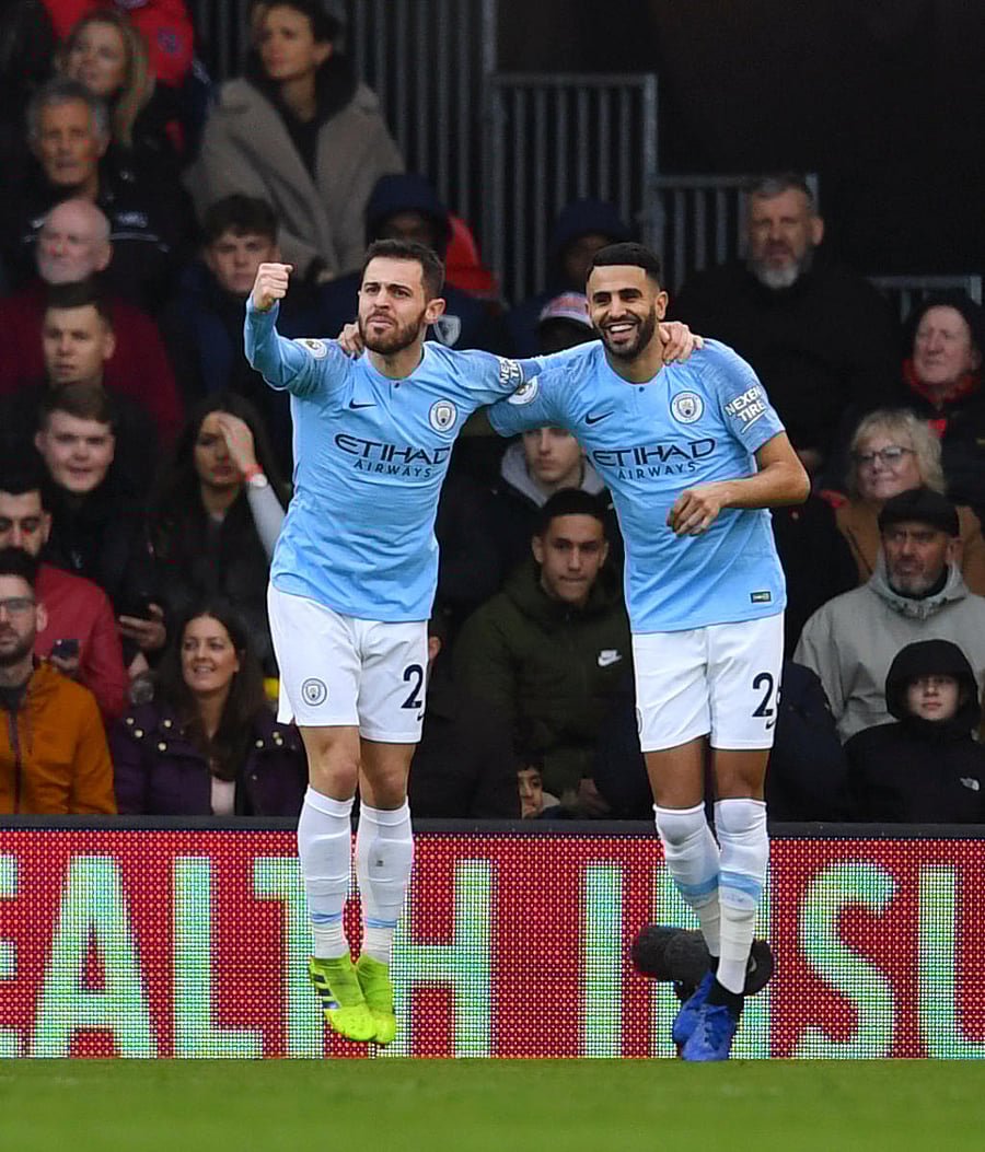 ON TARGET: Manchester City's Riyad Mahrez (right) celebrates after scoring against Bournemouth. REUTERS
