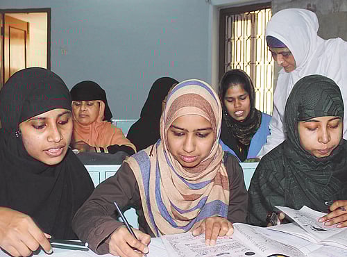 Begum Shehnaz Sidarat watches as girls study in madrasa at Firangimahal in Lucknow, Dh photo