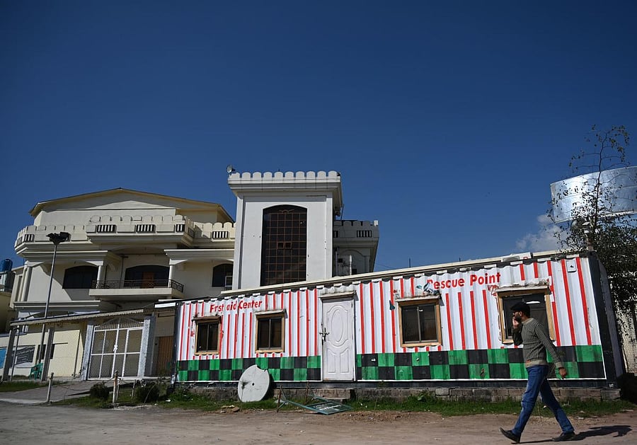 A man walks past a closed medical dispensary and offices of the Falah-e-Insaniat Foundation, a charity organization set up by Jamaat-ud-Dawa -- the political arm of the banned Islamist militant group Lashkar-e-Taiba. (AFP Photo)