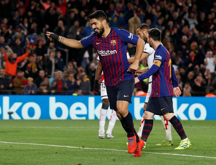 MERCURIAL: Barcelona's Luis Suarez celebrates scoring their third goal against Rayo Vallecano. Reuters