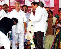 showing reverence:  A TV grab shows BJP State President K S Eshwarappa touches the feet of former chief minister  B S&#8200;Yeddyurappa during the inauguration of a hi-tech KSRTC&#8200;bus terminus in Shimoga on Thursday.
