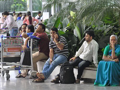 Passengers waiting at the Kempegowda international airport, flights are rescheduled during the Karnataka bandh in Bengaluru on Saturday. DH photo