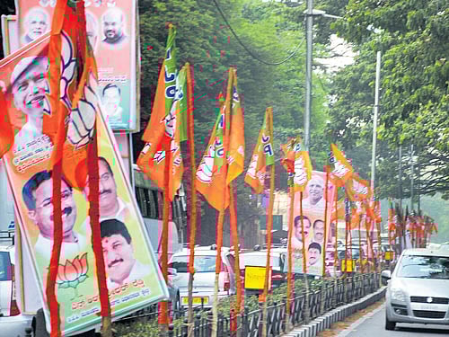 Flex boards and BJP flags deck Ballari Road on the eve of the first public meeting to be held to mark B S Yeddyurappa's appointment as state BJP chief. DH photo