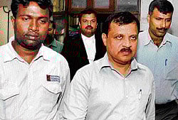 trapped: Bangalore Rural Deputy Commissioner M K Aiyappa being arrested by the Lokayukta police in Bangalore on Wednesday. DH Photo/Kishor Kumar Bolar