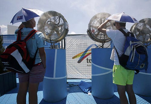 Spectators cool off in front of misting fans at the Australian Open 2014 tennis tournament in Melbourne January 16, 2014. Play on the outer courts at the Australian Open was called to a halt on Thursday when temperatures hit 43.3 degrees Celsius (110 Fahrenheit) on a third straight day of sweltering heat at Melbourne Park. Organisers, who had been slammed for forcing players to play on in searing temperatures on Tuesday and Wednesday, enacted the third stage of their 'Extreme Heat Policy' for the first time at about 1.50pm local time (0250 GMT). REUTERS