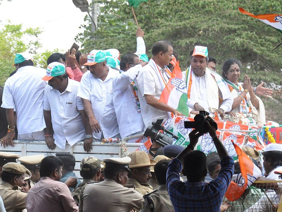 Chief Minister Siddaramaiah and Congress candidate Geetha Mahadev Prasad at an election rally in Gundlupet of Chamarajanagar district on Sunday.