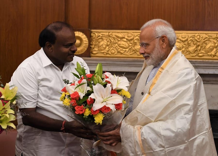 Karnataka Chief Minister H D Kumaraswamy greets Prime Minister Narendra Modi, in New Delhi on Monday. (Pic released by Press Information Bureau)