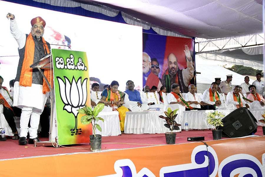 iN FULL FORCE: BJP president Amit Shah addresses a BJP rally in SINDHANUR on Thursday. Party general secretary Muralidhar Rao, former chief minister Jagadish Shettar, MP Sanganna Karadi and others are seen. dh photo