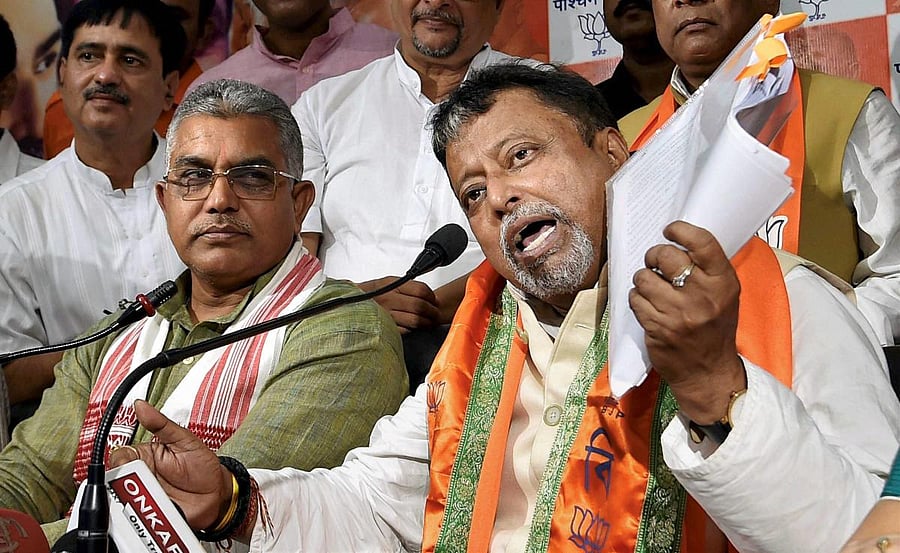 West Bengal BJP President Dilip Ghosh (L) and BJP leader Mukul Roy. PTI file photo