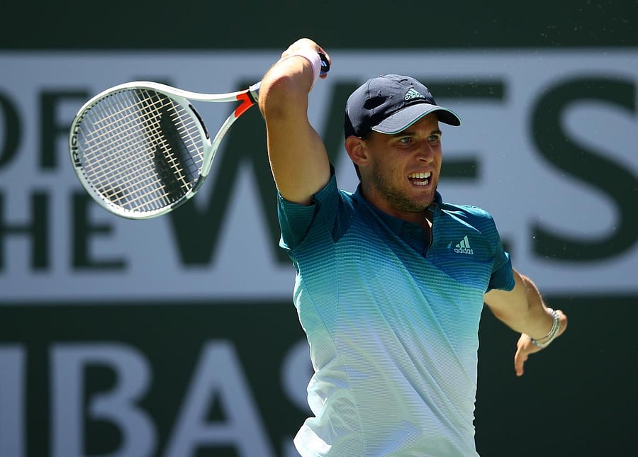 GUTSY: Dominic Thiem of Austria returns during his semifinal win over Milos Raonic of Canada. AFP