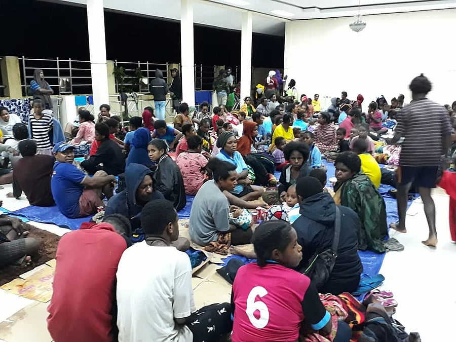 This handout picture taken and released by Indonesia's Badan Nasional Penanggulangan Bencana (BNPB), the accident mitigation agency, on March 17, 2019 shows local residents gather at a temporary shelter in Sentani, near the provincial capital of Jayapura, as floodwaters triggered by torrential rain swarmed the area. At least 42 people have been killed by flash floods in IndonesiaÕs eastern Papua province, an official said. - At least 42 people have been killed by flash floods. AFP photo