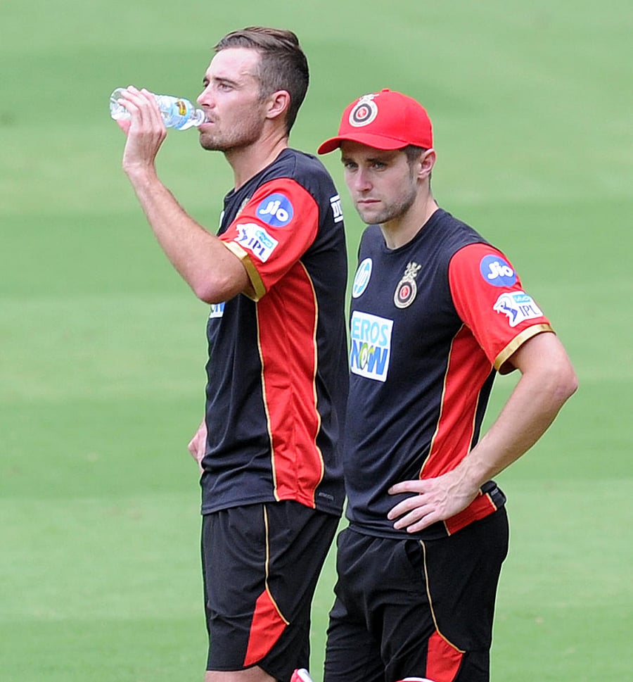 RCB pacemen Tim Southee (left) and Chris Wokes during a practice session at the M Chinnaswamy Stadium in Bengaluru on Monday. DH Photo/ Srikanta Sharma R