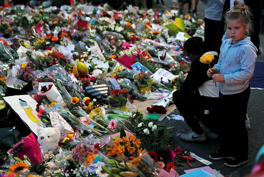 People visit a memorial site for victims of Friday's shooting, in front of the Masjid Al Noor mosque in Christchurch, New Zealand March 18, 2019. REUTERS