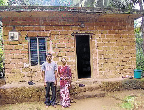 Inspiring:  Manjunath with his mother in front of his house in Subramanya in Dakshina  Kannada district. (Below) Manjunath operates a computer at his house. DH Photos
