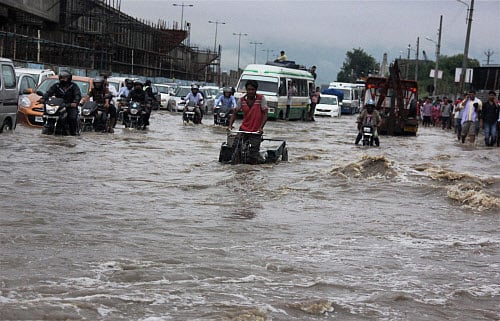 Traffic at a flooded road at Hero Honda Chowk on Delhi-Gurgaon Expressway after heavy rains in Gurgaon on Wednesday. PTI Photo