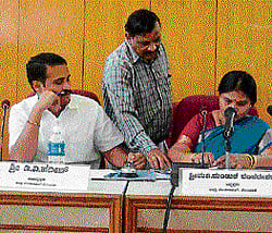 Taking stock: ZP president Manjula reviews the file recommending the suspension of Social Welfare officer, Anand on Tuesday at a progress review meeting in Kolar. Dh Photo