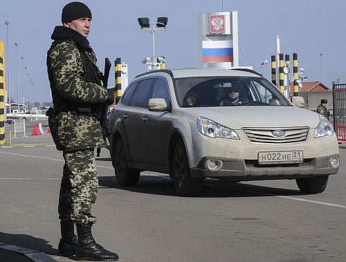 A Ukrainian frontier guard works at the crossing point on the border with Russia in Goptovka near Kharkiv Reuters Image