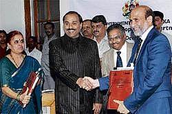 Inking development: Tourism and Infrastructure Minister G Janardhana Reddy greets CMD, MARG Limited, G R K Reddy at the signing of Project Development Agreement for Development of Greenfield Airport-Bellary, at Vikasa Soudha in Bangalore on Friday. Also seen are Principal Secretary, Department of Infrastructure Development, V Madhu and Under Secretary, N Manjula Geetha. KPN