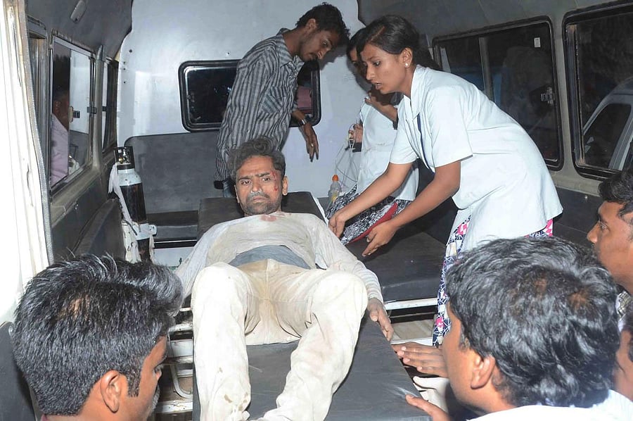 A rescued construction worker is taken out form an ambulance on a stretcher to a local hospital after he was rescued from the rubble after an under-construction multi-storey building collapsed in Dharwad district of Karnataka situated about 700 kilometres north of Bangalore on March 19, 2019. - At least two people have died and dozens are feared trapped under rubble after a building site collapsed March 19 in India's southern Karnataka state, officials told AFP. AFP photo