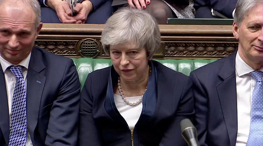 Prime Minister Theresa May sits down in Parliament after the vote on May's Brexit deal, in London. Reuters photo