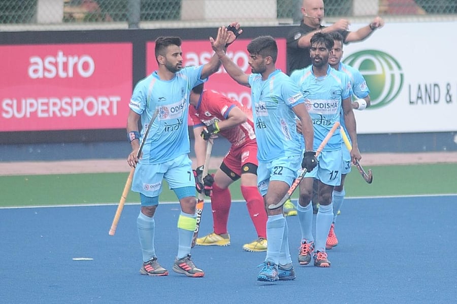 India's Varun Kumar (No 22) celebrates with Manpreet Singh (left) after scoring against Japan on Saturday. HI MEDIA