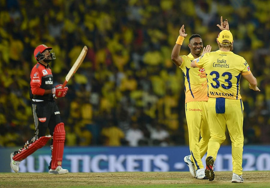 Chennai Super Kings cricketer Dwayne Bravo (C), Shane Watson (R) celebrates a wicket of Royal Challengers Bangalore's Parthiv Patel during the Indian Premier League (IPL) Twenty20 cricket match between Chennai Super Kings and Royal Challengers Bangalore a