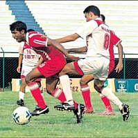 KEEN TUSSLE: SBTs Mohammed Harris (right) tackles Firoz K of Malabar United in the I-League II Division match at the Bangalore Football stadium on Monday. DH PHOTO